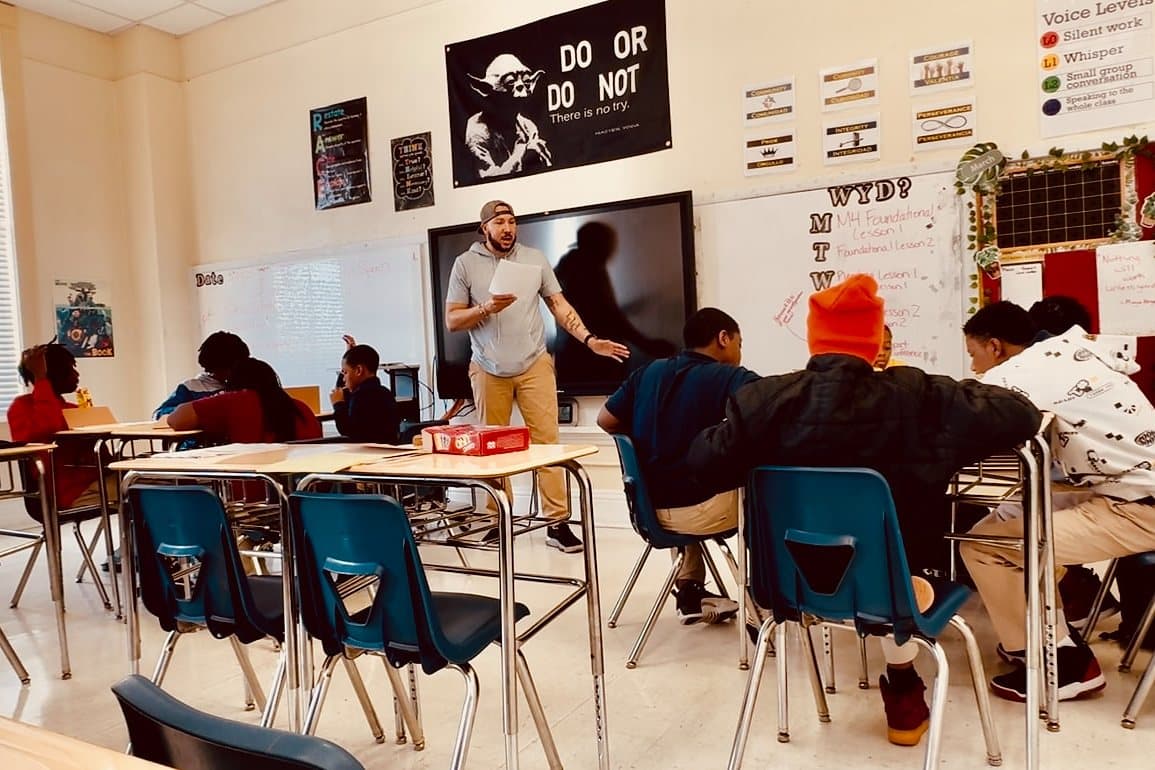 Students at desks in a classroom during a mentoring session