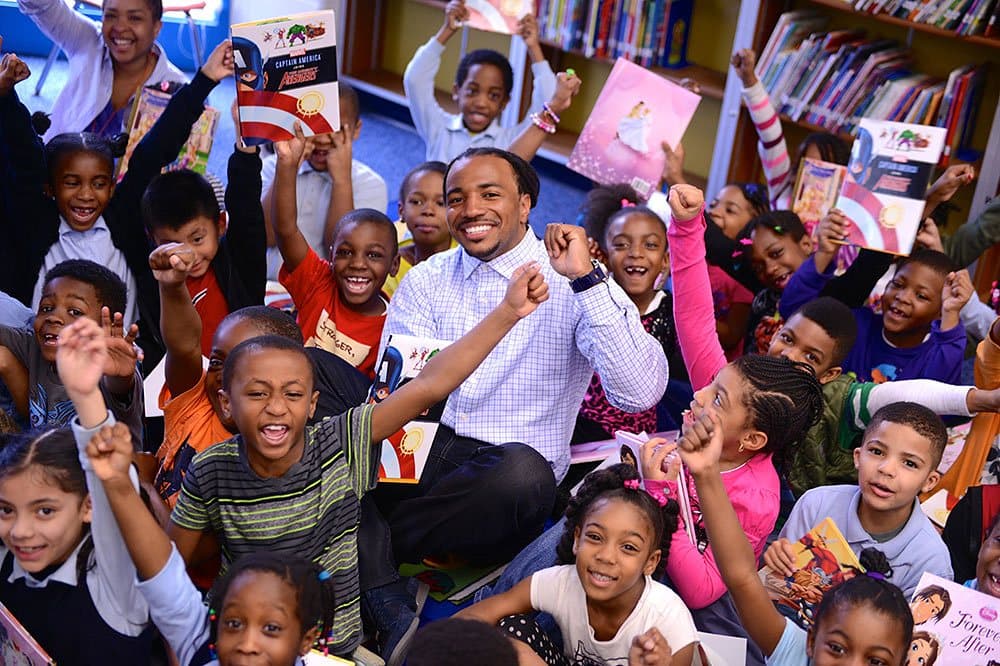 Children in a school library cheering and holding books